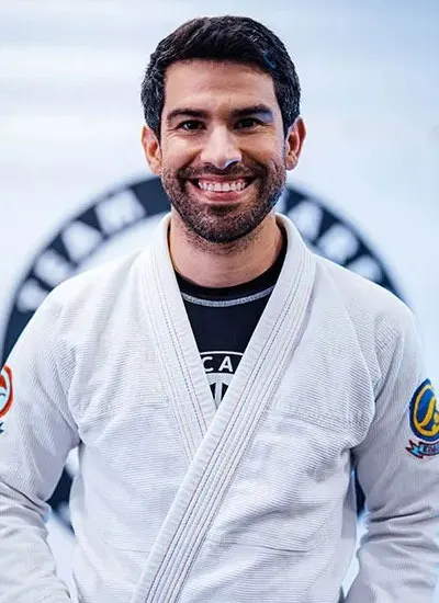 Smiling Team Casarez instructor wearing a white gi